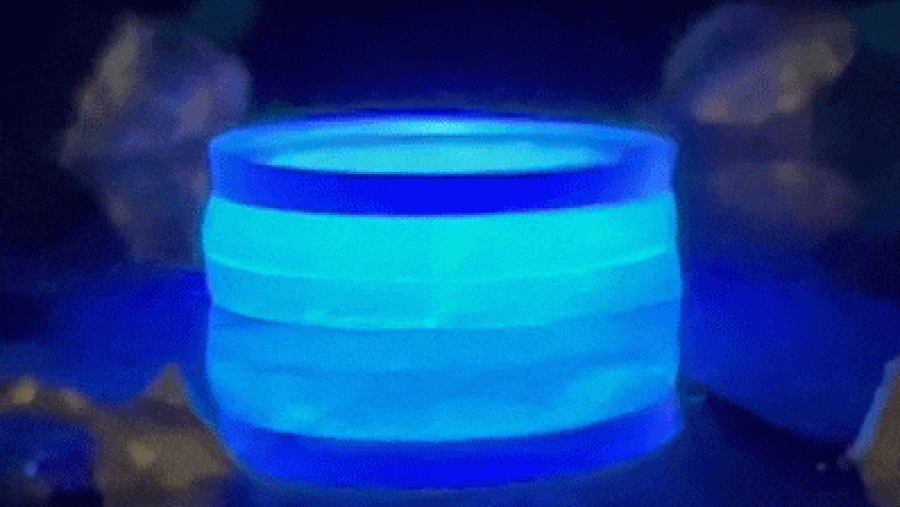 a small wobbly object spinning around and glowing blue